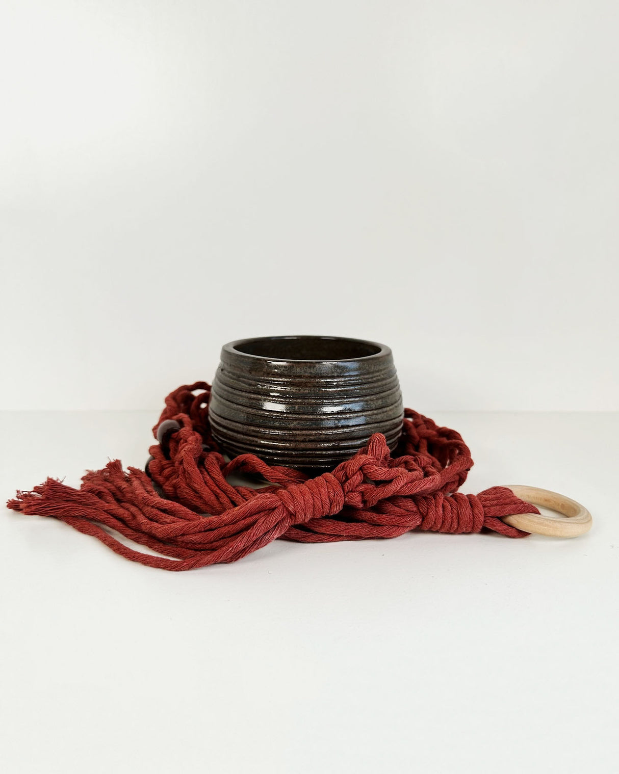 Ridged Deep Brown Stoneware Planter with Red Macrame Hanger | Lucinda Meglemre