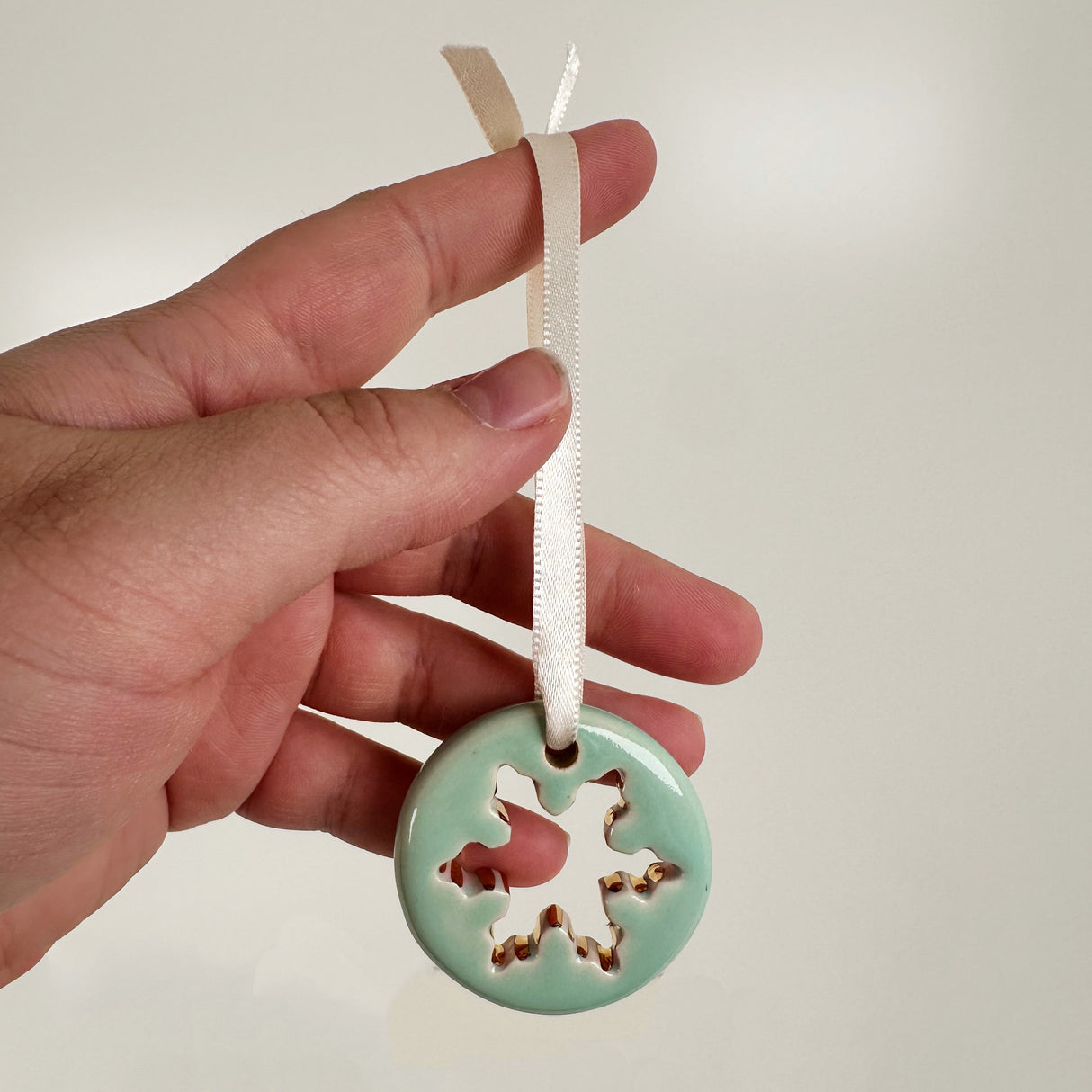 Hand Painted Snowflake Cut Out Patterned Ceramic Ornament in Sea Foam Green | Terra Clay